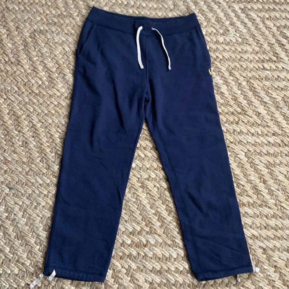 Polo navy sweatpants, two pockets, one in back, toes on the ankles.
